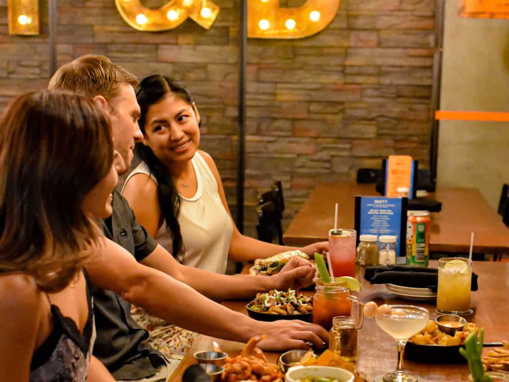 Enjoying delicious food and drinks with friends at Bite Club Cayman restaurant. Perfect place for social gatherings in Cayman.